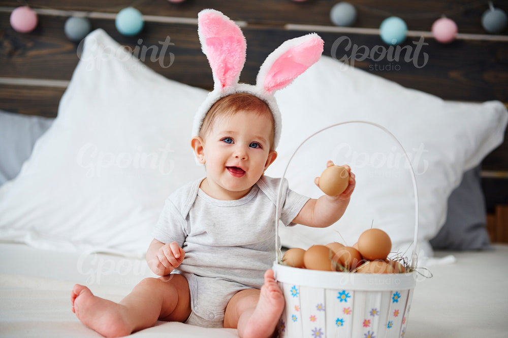Portrait of adorable baby girl with easter basket