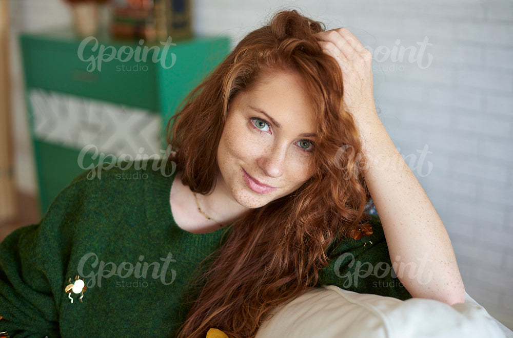 Portrait of smiling, red haired girl with freckles