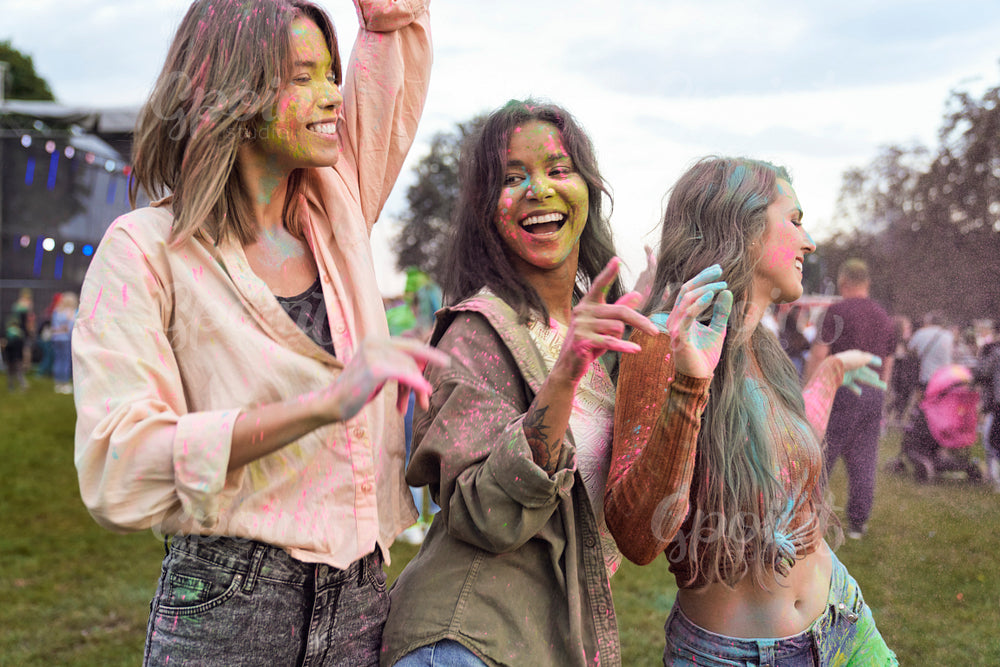 Group of multiracial friends have fun at Holi Festival  