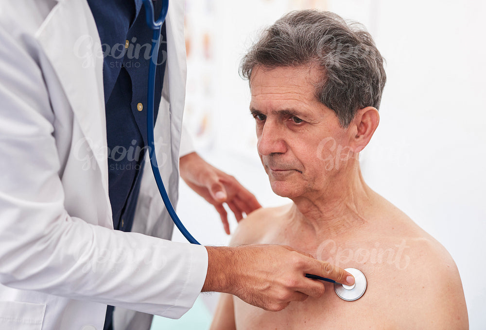 Close up of doctor examining senior man