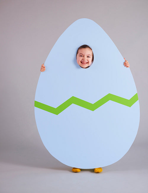 Cheerful child holding a huge easter egg