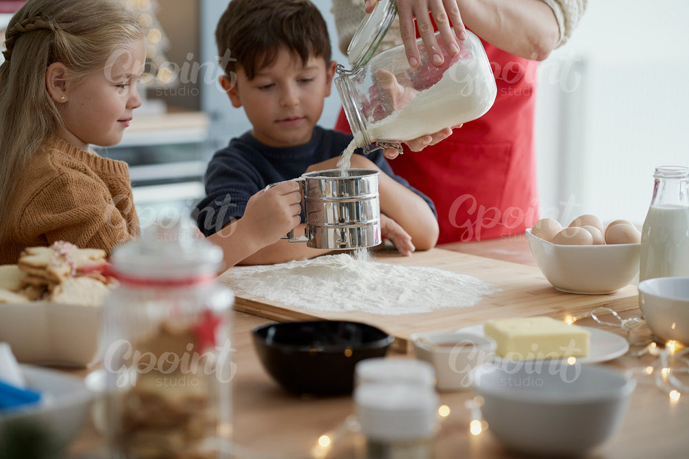 Affectionate children baking with their mother
