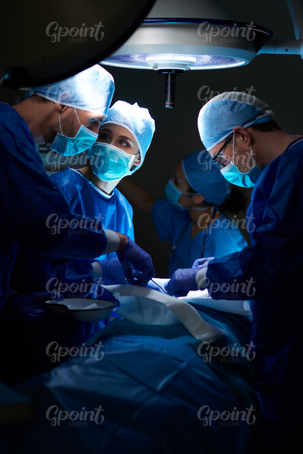 Team of surgeons making important operation