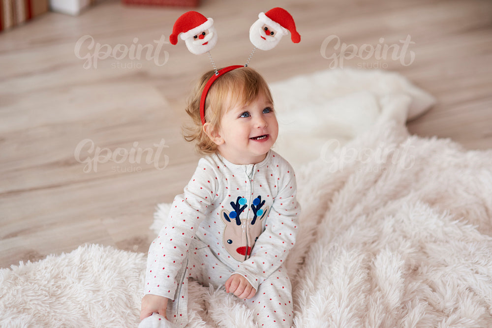 Charming baby in Christmas morning