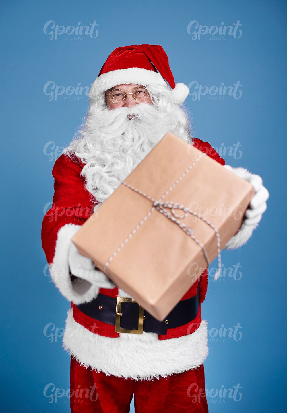 Man in santa claus costume giving christmas presents