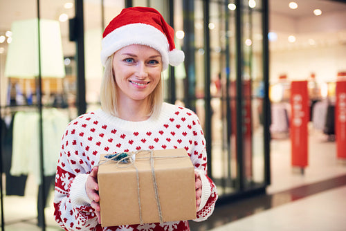 Beautiful women with santa hat and christmas present