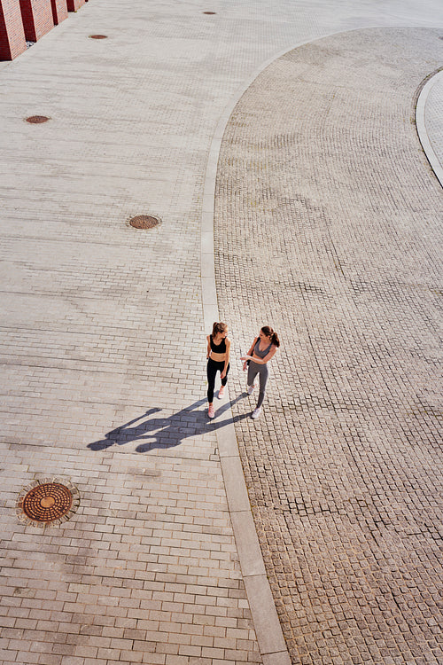 Top view of two athletic women going to training