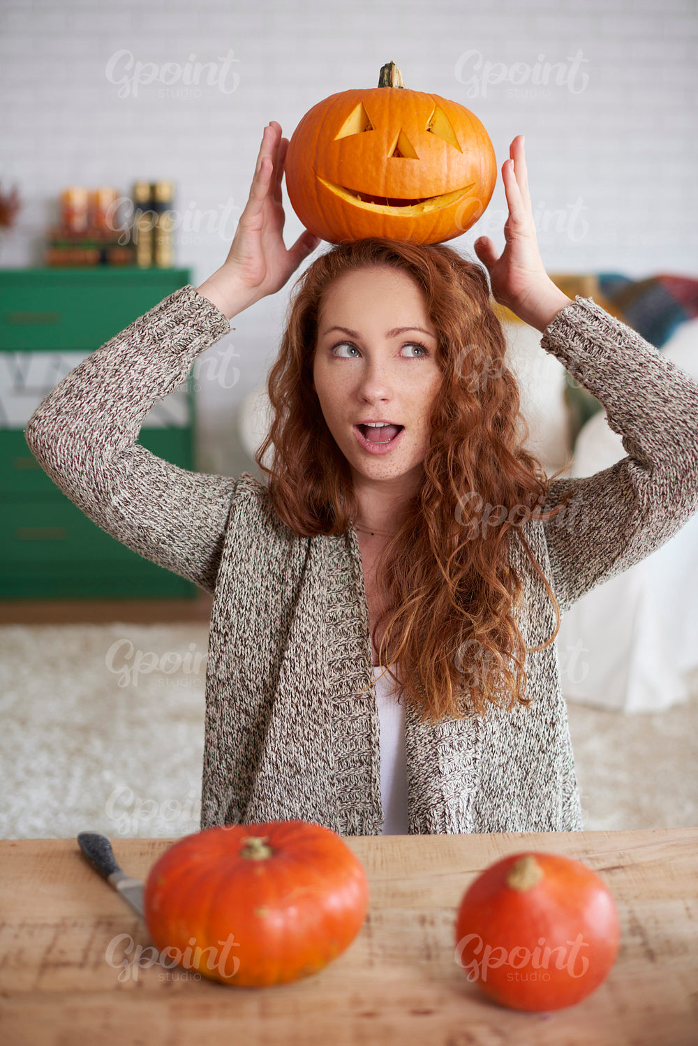 Playful girl with halloween pumpkin