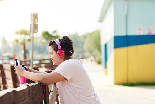 Woman choosing the best song for running