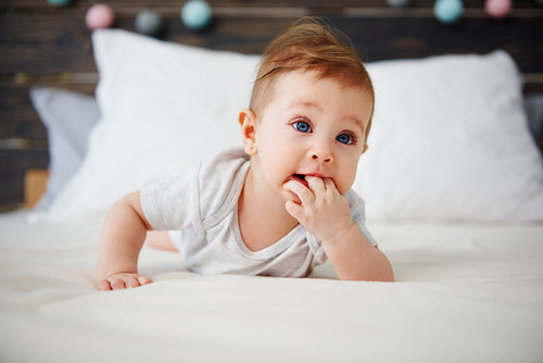Portrait of baby lying on the bed
