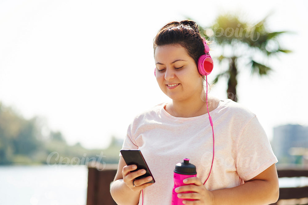 Woman choosing playlist for morning running