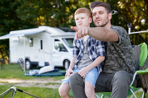Father and son do fishing on camper trip