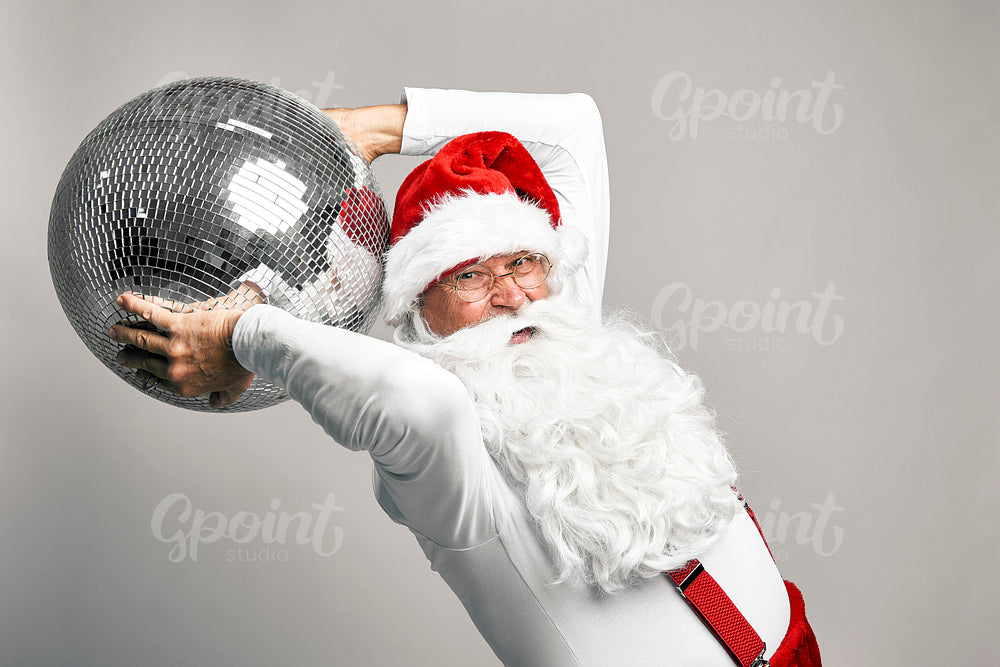 Close up of caucasian Santa Claus with disco ball on grey background 