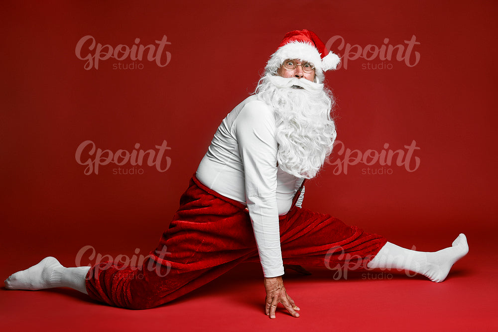 Shocked caucasian Santa Claus does the splits 
