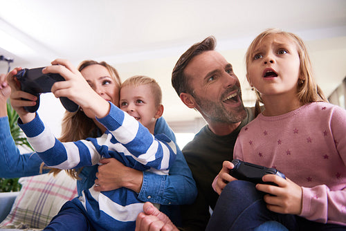 Emotional parents and children playing video game