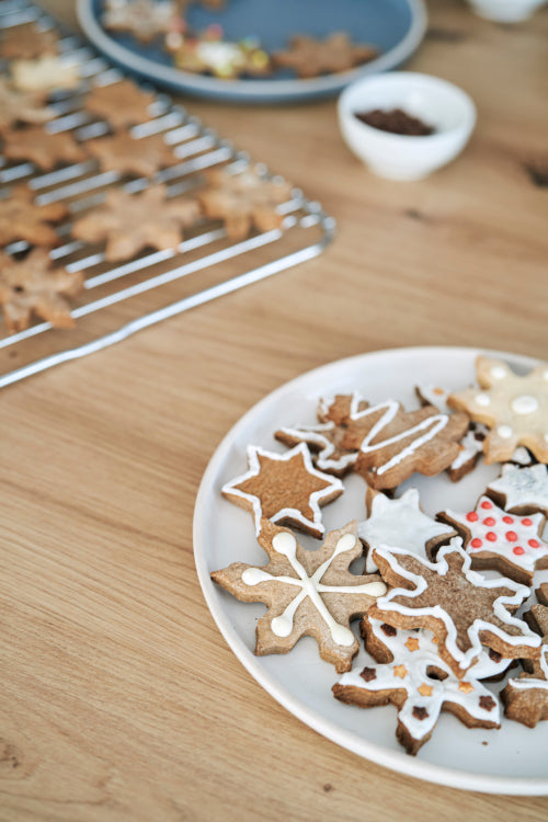 Detail of decorated Christmas cookies on kitchen worktop