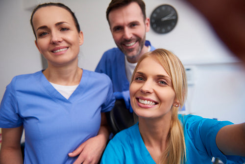 Team of smiling dentists in dentist's office