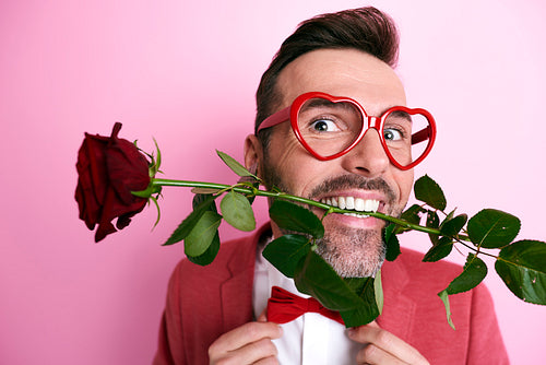 Man holding a rose in mouth