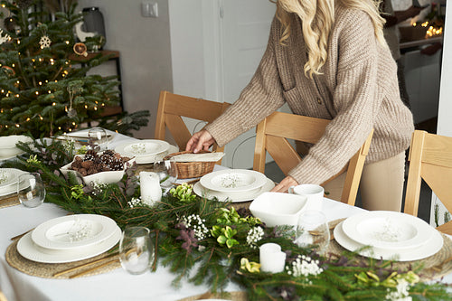 Unrecognizable caucasian women preparing table for Christmas Eve