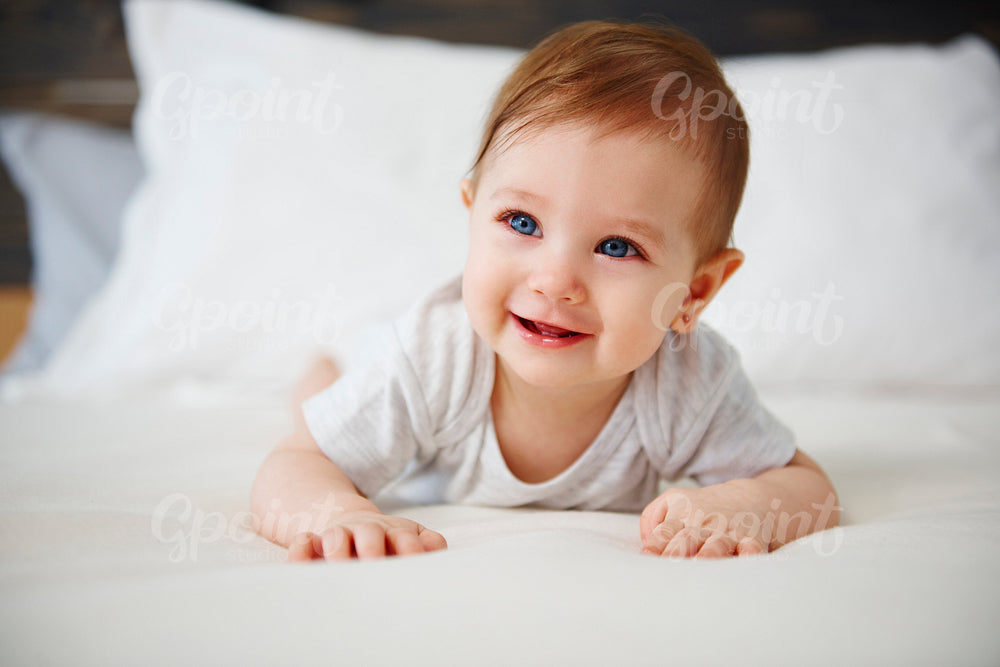 Charming baby lying on the bed