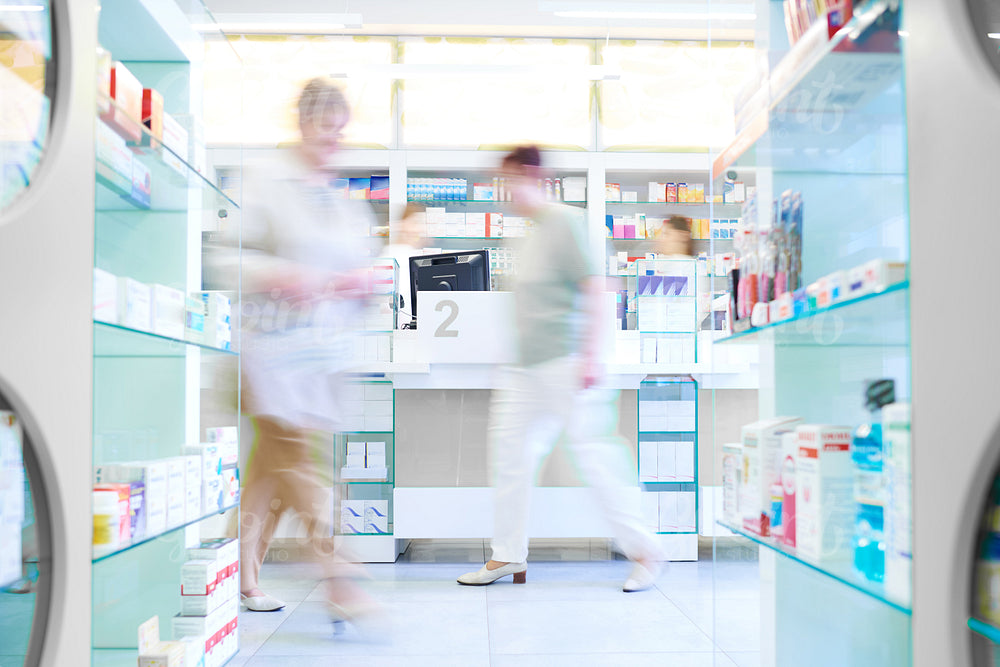 Defocused picture of customers shopping in pharmacy