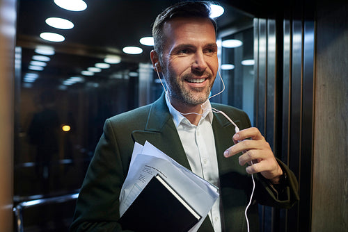 Smiling businessman in the elevator
