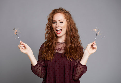 Shot of screaming woman showing heart shaped sparklers