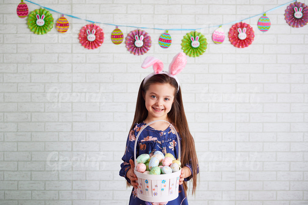 Portrait of smiling child holding a basket of easter eggs