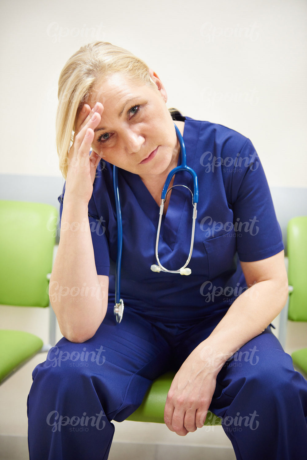 Portrait of tired mature doctor