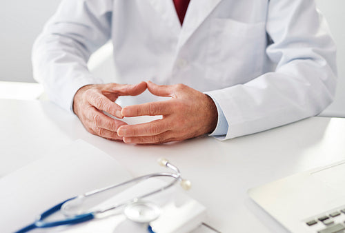 Close up of a doctor sitting at a desk