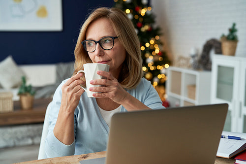 Mature woman drinking coffee and looking away