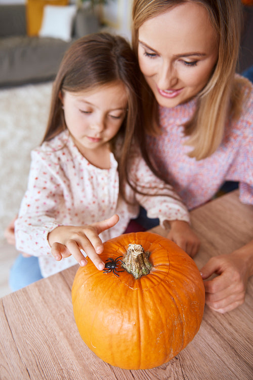 Mother and daughter making decorations for Halloween