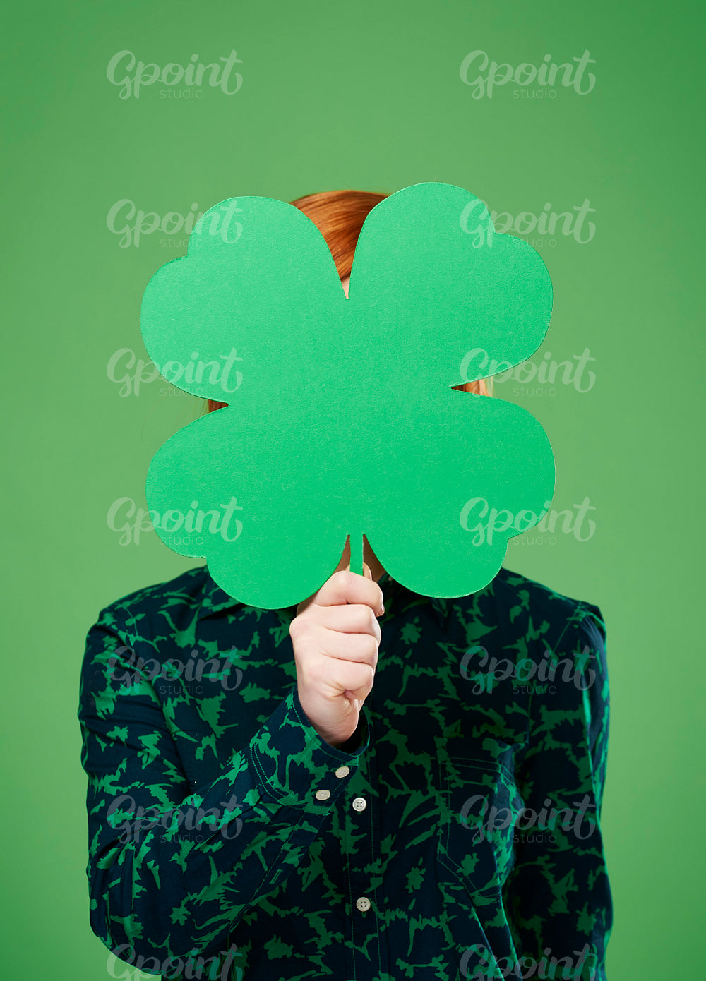 Woman's hand holding a four leaf clover
