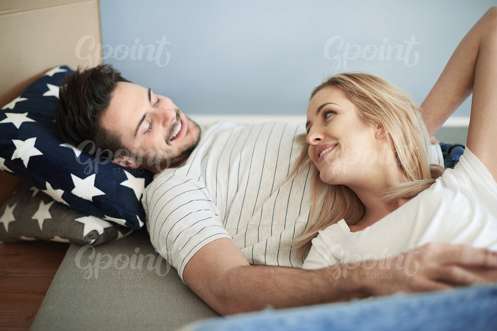 Couple lying down on the mattress