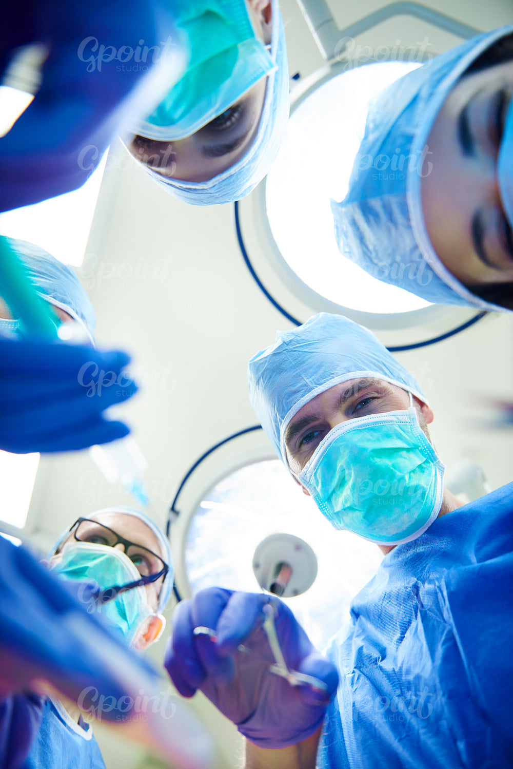 Low angle view of operating surgeons