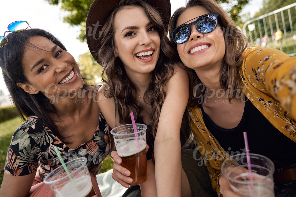 Group of friends making selfie at music festival 