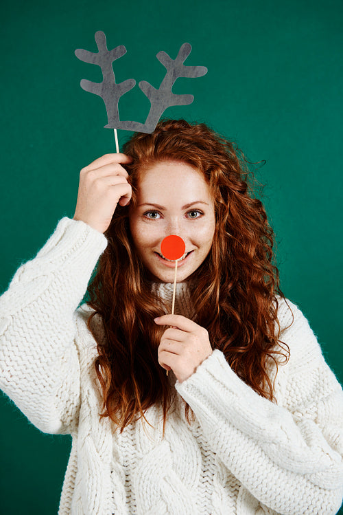 Woman in christmas mask on green background