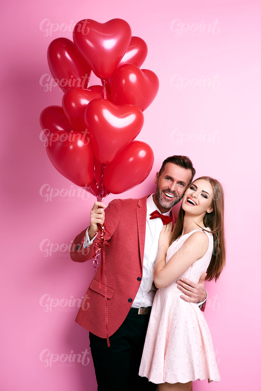 Portrait of embraced affectionate couple with balloon