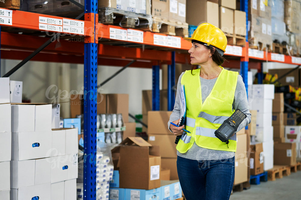 Adult caucasian woman working in warehouse 