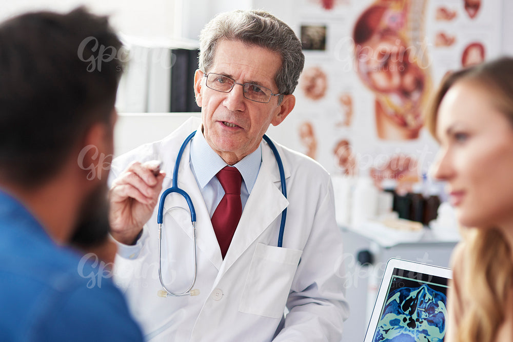 Gynecologist giving young couple good advice