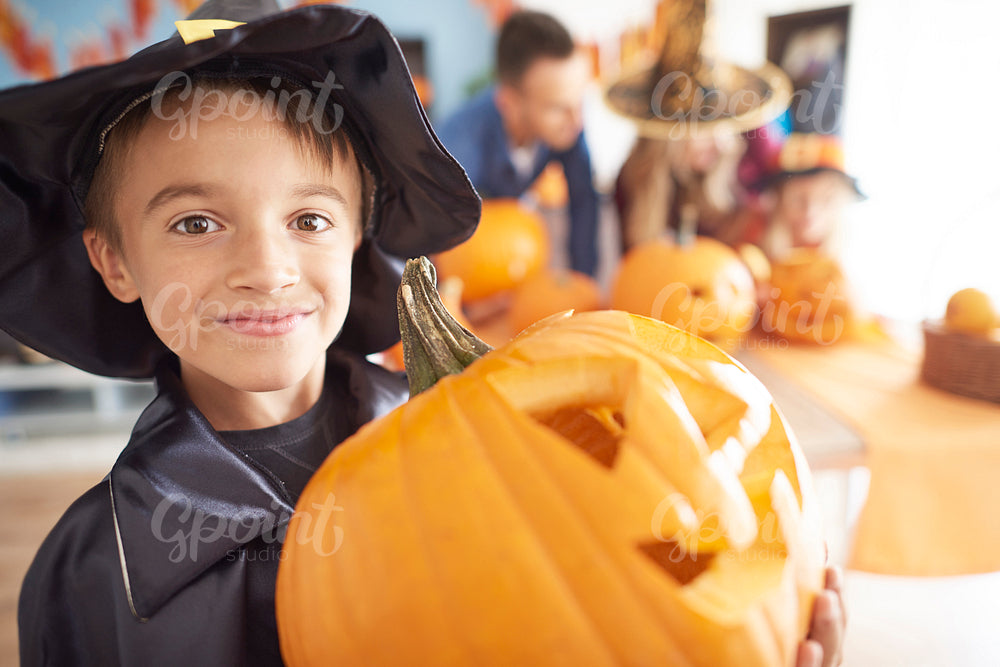 Little boy with big Halloween pumpkin