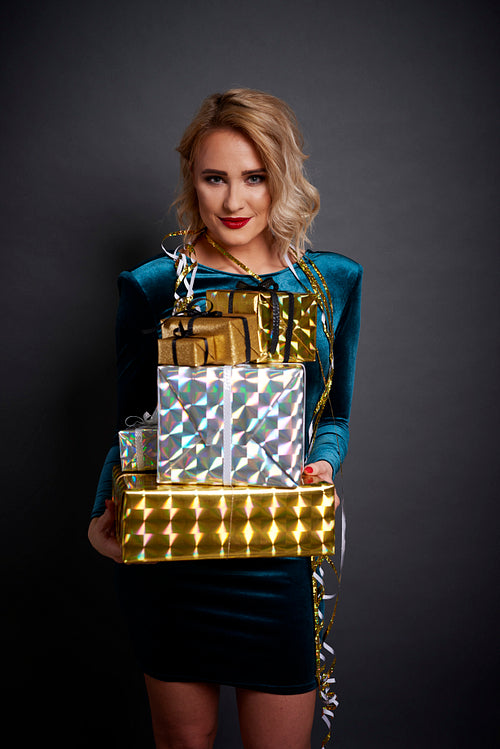Beautiful woman holding a stack of gifts