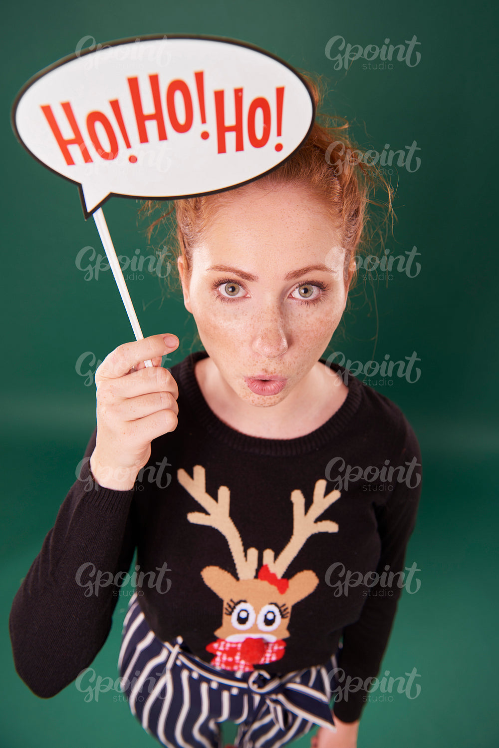 Portrait of woman holding christmas banner