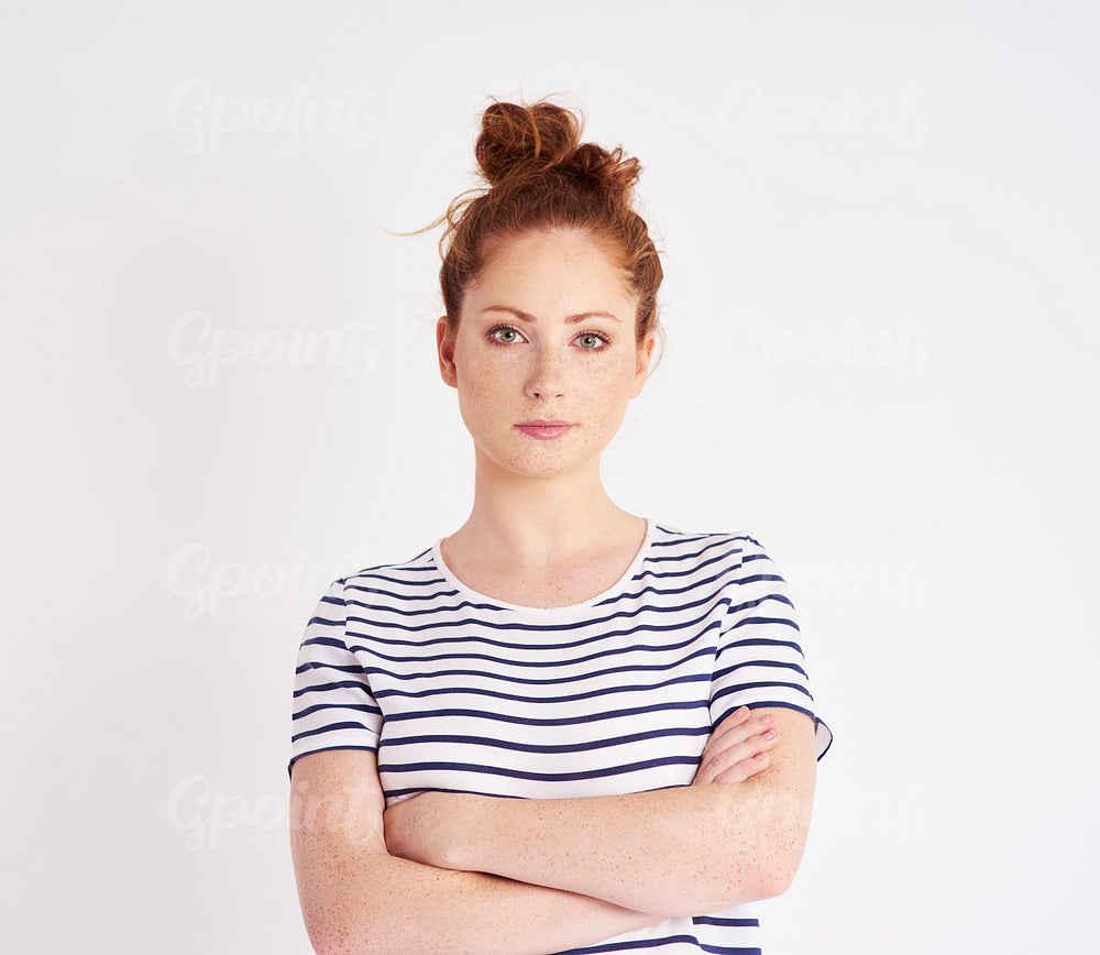 Portrait of beautiful woman with arms crossed at studio shot