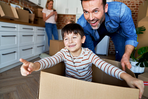 Son and father have fun during moving home
