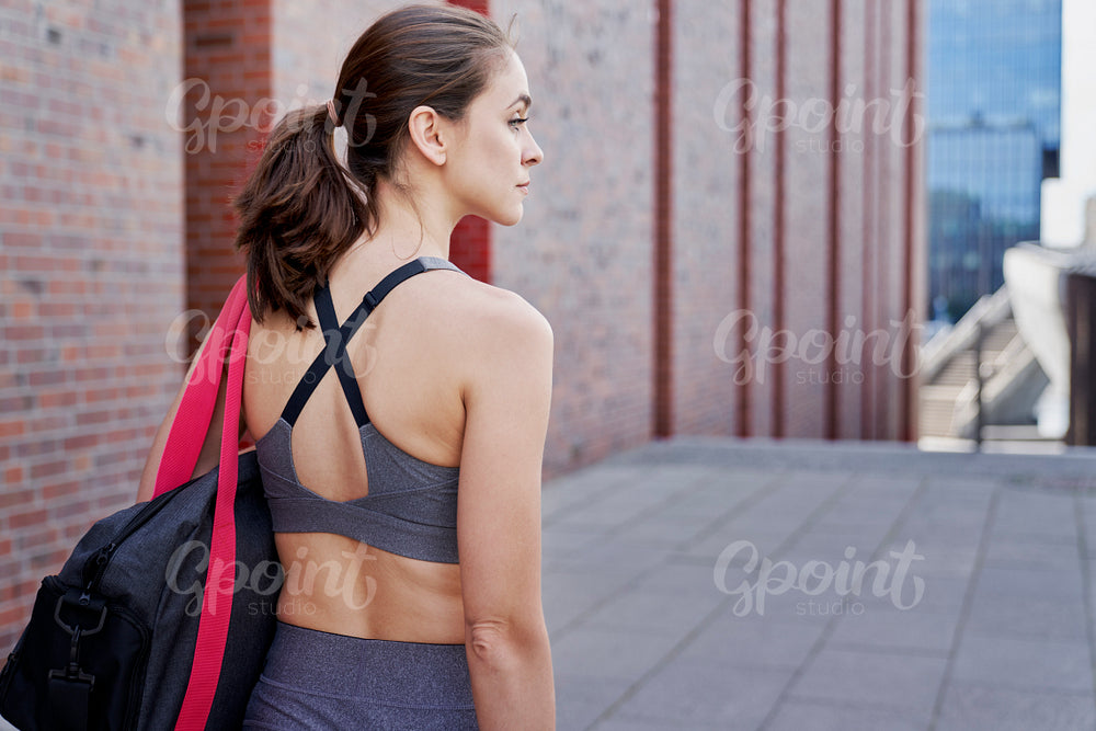 Rear view of athletic woman in training clothes