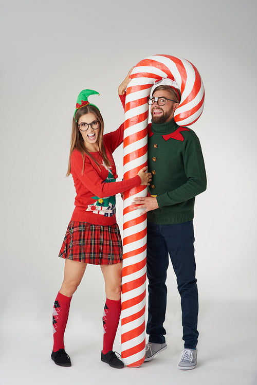 Couple posing with a huge candy cane