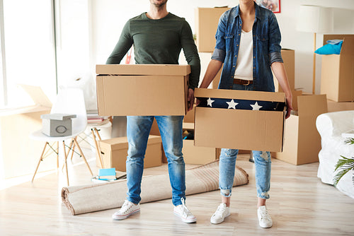Front view of couple with cardboard boxes