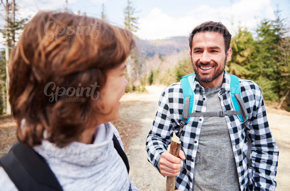 Smiling man with backpack hiking