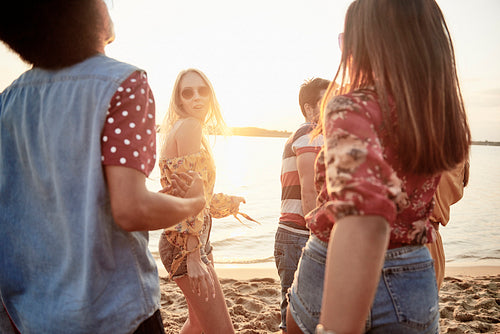 Young people dancing on the beach